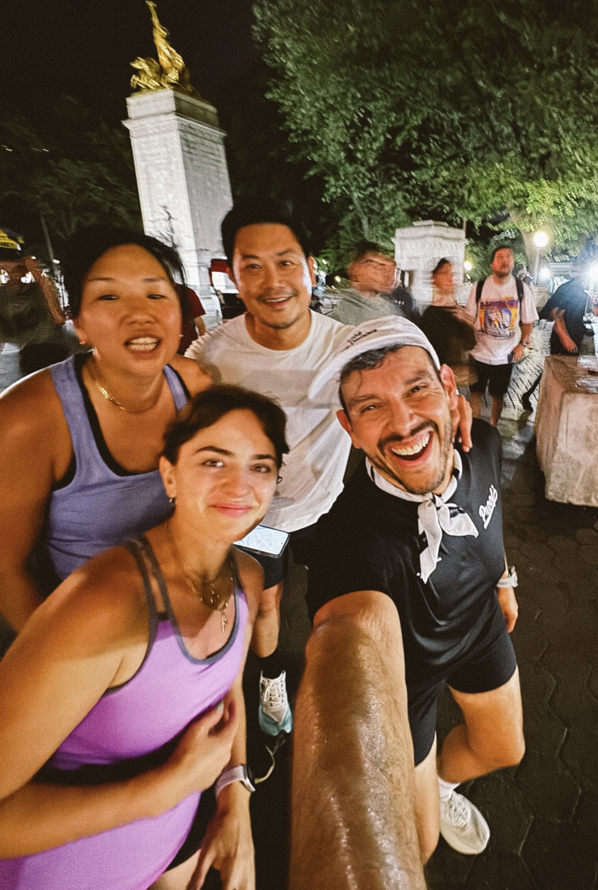 Marco smiling with a group of runners in New York City