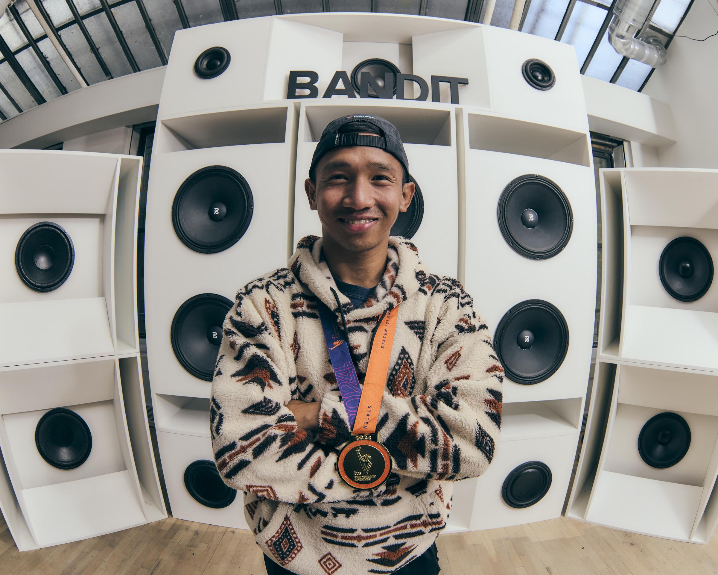 Timothy Angob smiling with his race medal